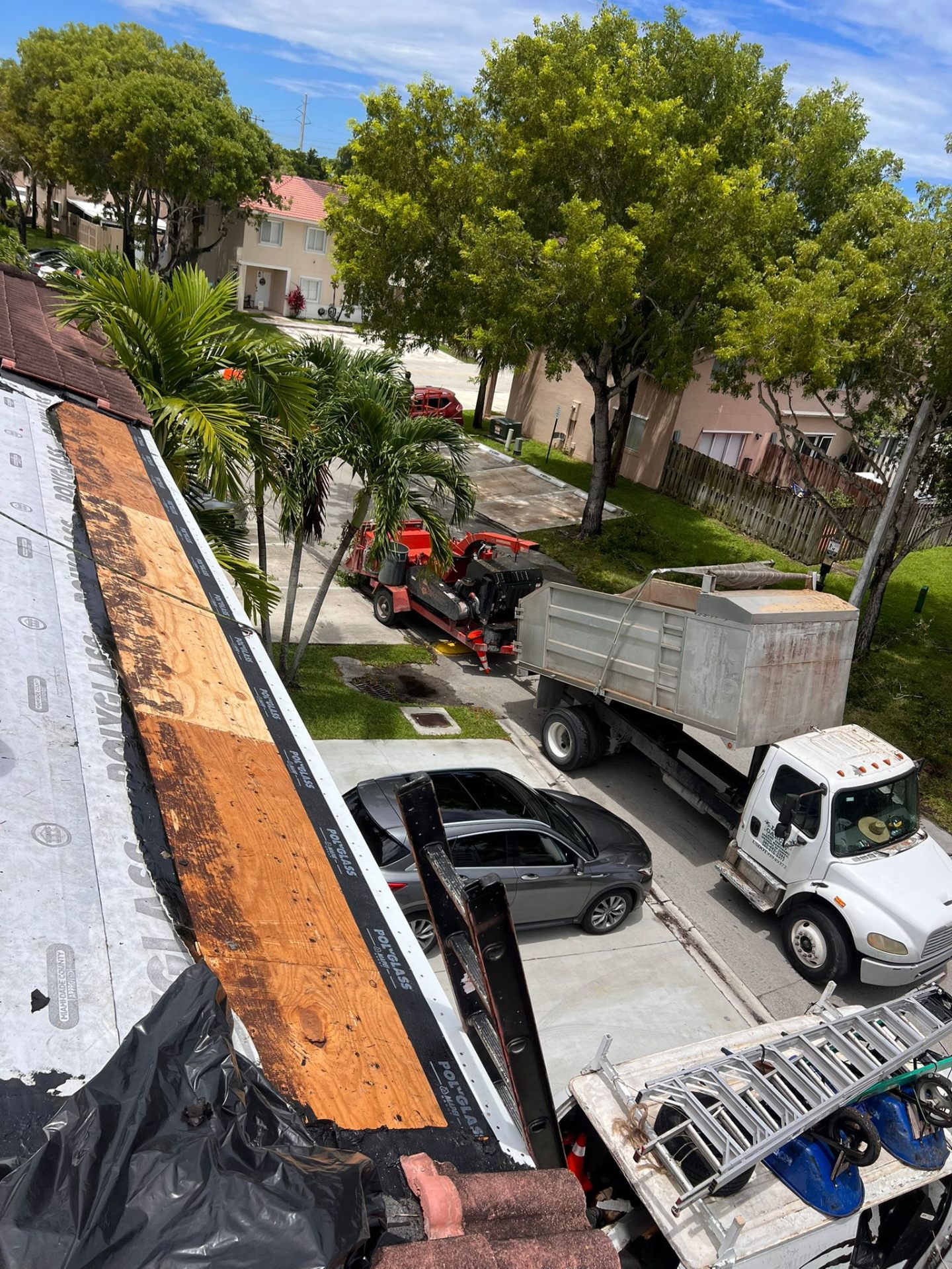Palm Beach Gardens residential roof replacement jobsite prepared beside a home