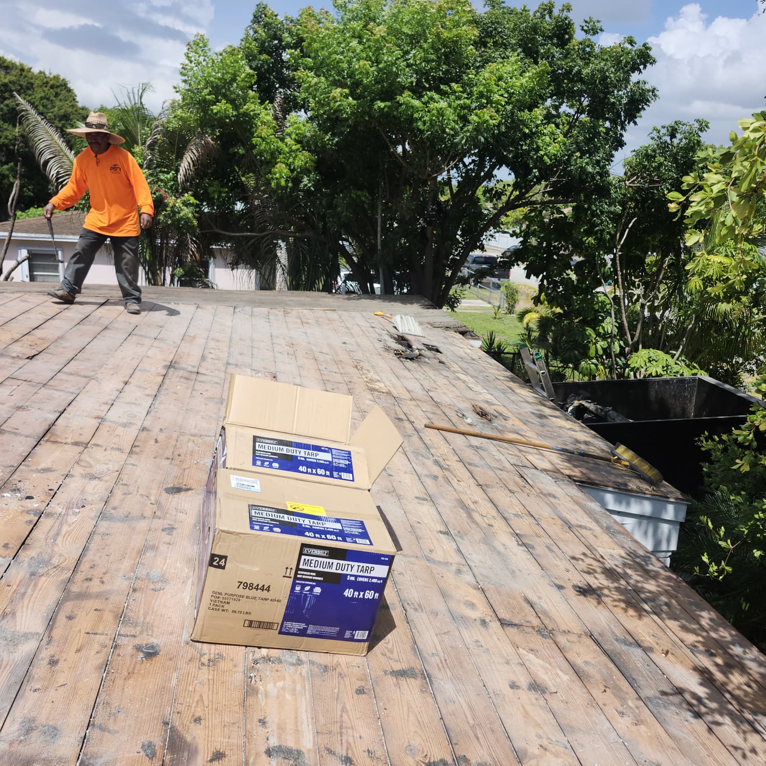 Licensed roofing crew performing warrantied roof repair work in Palm Beach Gardens