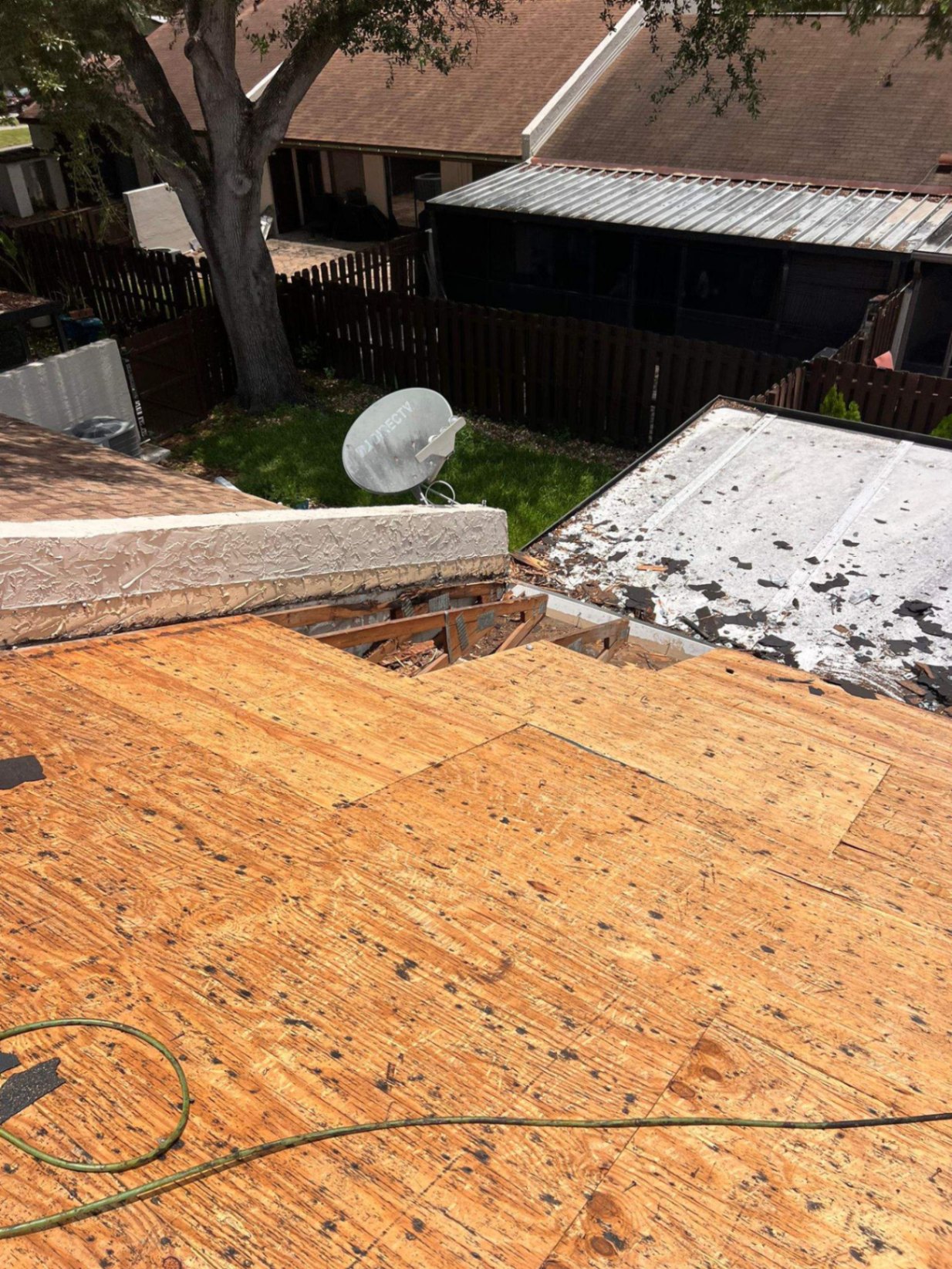 Roofing technician performing roof repair on a Palm Beach Gardens home