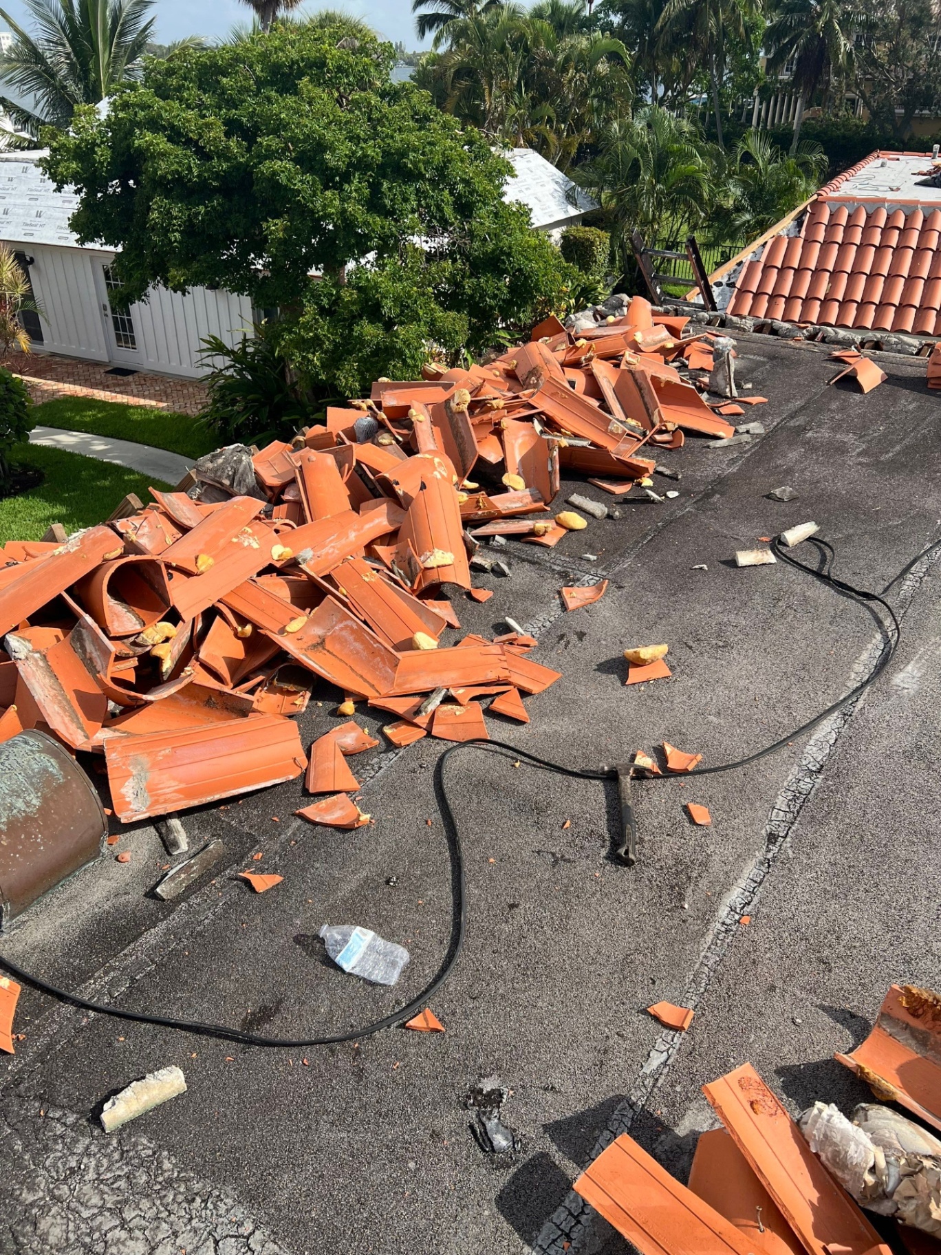Professional roof replacement project in Palm Beach Gardens showing new shingles being installed on a residential home